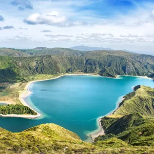 Aerial view of Lagoa do Fogo, a blue lake surrounded by green hills in the Azores.