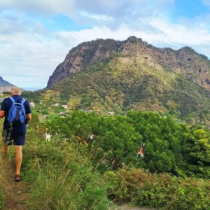 Group of hikers walking along a path with Castelejo Mountain in the background.